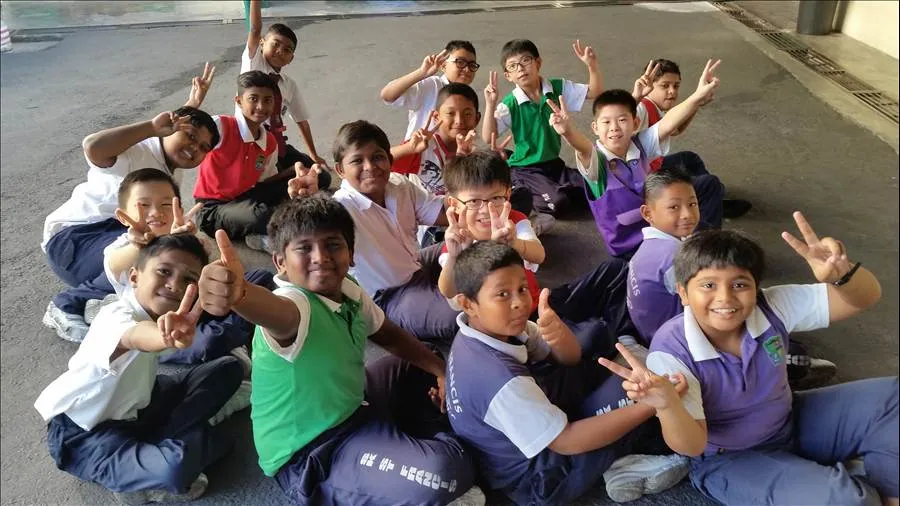 Group of smiling children posing together after receiving free eye care services.